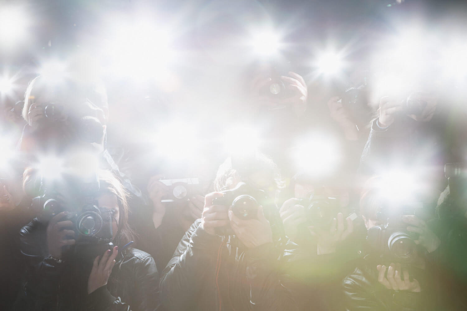 Flashing lights from paparazzi cameras taking pictures of celebrities after cosmetic dentistry