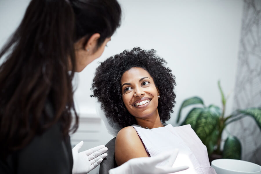 Brunette woman smiles after a successful smile restoration in Fayetteville, AR