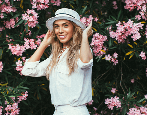 young woman with hat on smiling