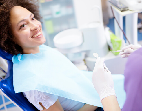 woman about to have her teeth examined by a dentist