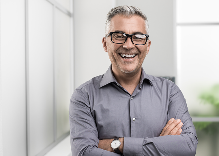 man with his arms crossed smiling