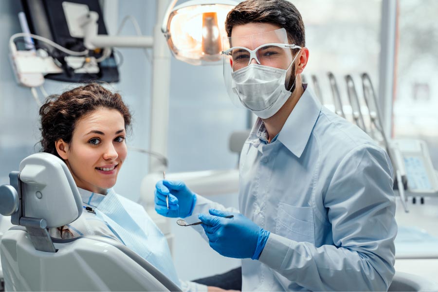 young girl sits in the dental chair to get a tooth cleaning and exam