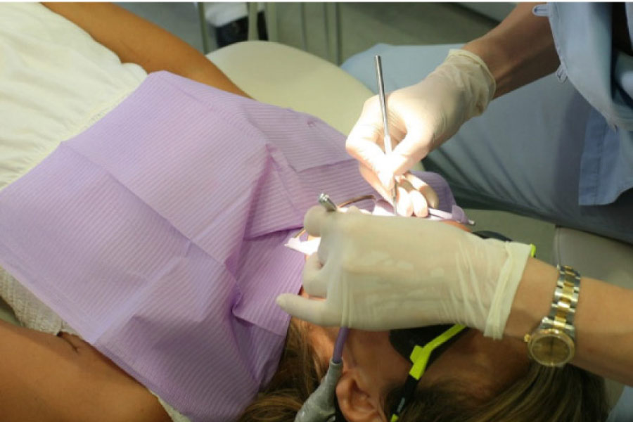 female patient undergoing oral surgery to extract a tooth