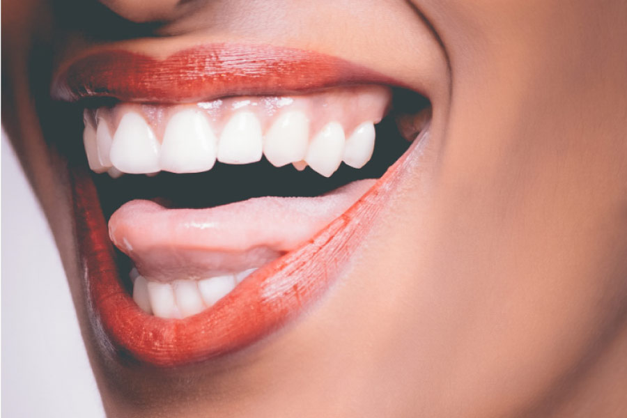 closeup of a woman's smile showing off her white tooth enamel